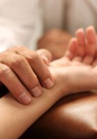 Doctor taking pulse of patient